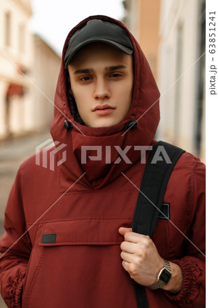 handsome young guy in a sporty red jacket  63851241