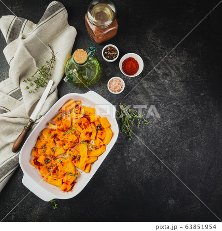 Roasted pumpkin slices with thyme 63851954