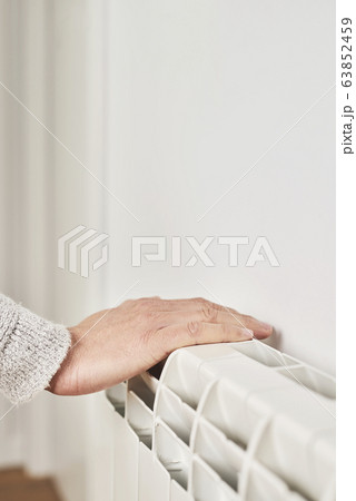 man touching a radiator man touching a radiator 63852459