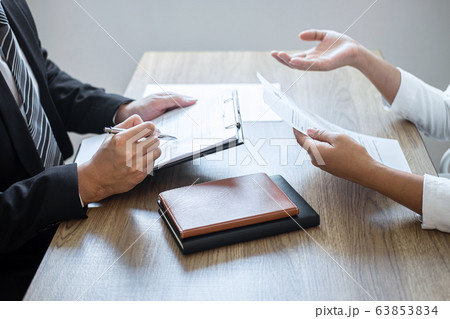 Employer or committee holding reading a resume 63853834