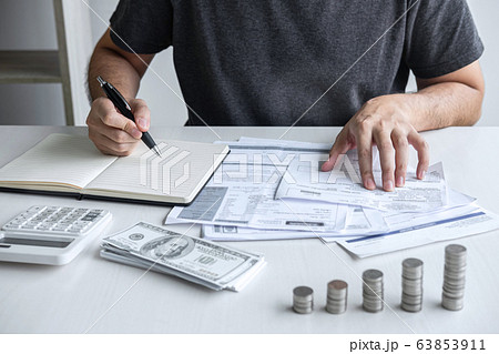 Images of stacking coin pile and Husband using Images of stacking coin pile and Husband using 63853911