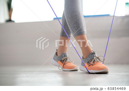 Female patient legs walking with jump rope 63854469