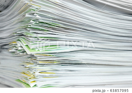 A stack of office papers on a table. A stack of office papers on a table. 63857095
