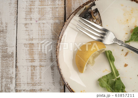 left overs of a salad on wooden table 63857211
