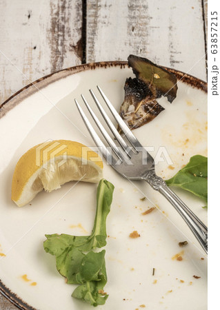 left overs of a salad on wooden table 63857215
