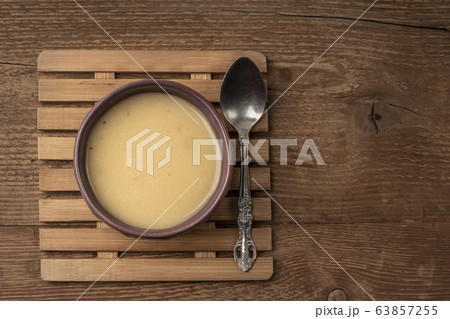 a bowl of soup on wooden table a bowl of soup on wooden table 63857255