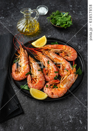 Vertical shot of a plate with red big prawns Vertical shot of a plate with red big prawns 63857858
