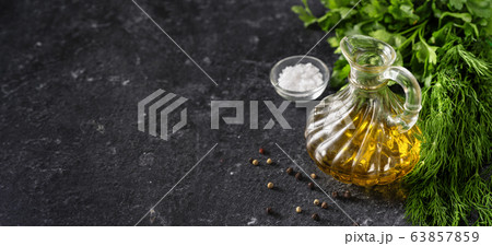 Herbs, olive oil and salt on black background 63857859