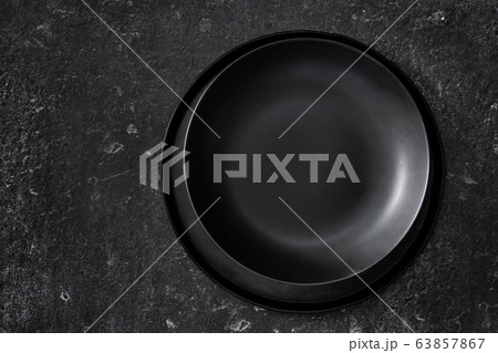 Top view of empty black plates on black background Top view of empty black plates on black background 63857867