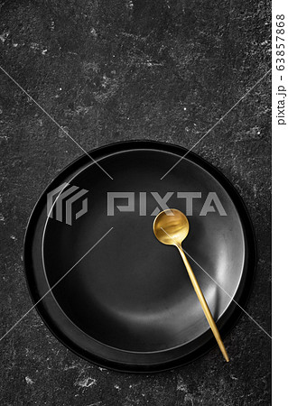 Vertical shot of empty black plate for soup on 63857868