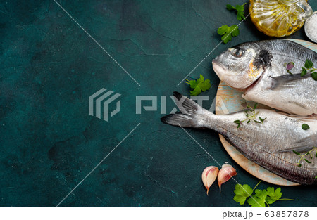 Raw dorado fishes and ingredients on trendy 63857878