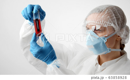 Doctor looking at vaccine test-tube 63858928