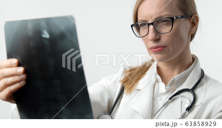 Female doctor examining x-ray picture 63858929