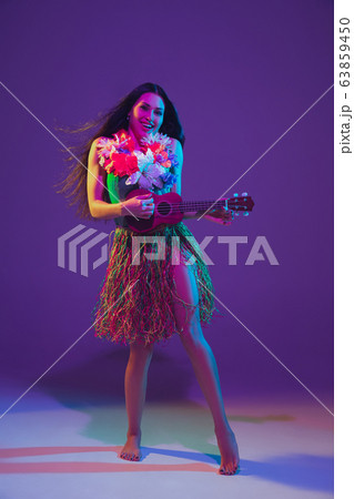 Fabulous Cinco de Mayo female dancer on purple studio background in neon light 63859450
