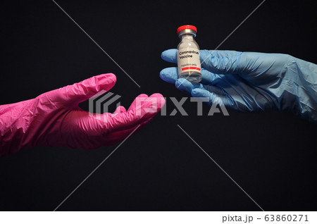 Woman Hand With Glove Giving Coronavirus Vaccine Woman Hand With Glove Giving Coronavirus Vaccine 63860271