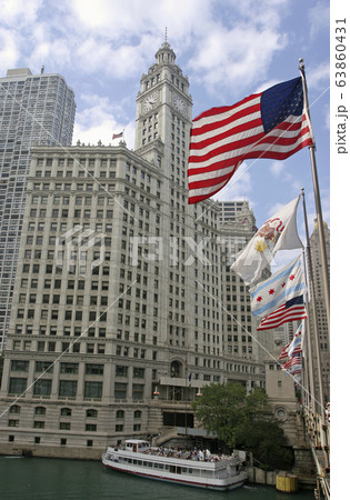 Wrigley Building on Michigan Avenue with American flag on the foreground in Chicago, USA 63860431