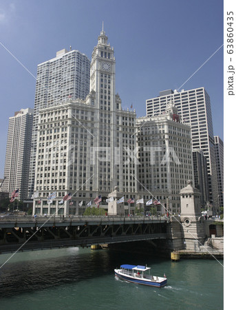 Wrigley Building on Chicago River with cruise boat on the foreground, USA 63860435