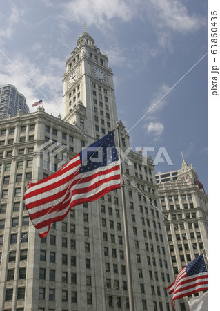 Wrigley Building on Michigan Avenue with American flag on the foreground in Chicago, USA Wrigley Building on Michigan Avenue with American flag on the foreground in Chicago, USA 63860436