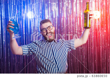 Alcoholism, fun and fool concept - Drunk crazy guy at party in a nightclub. 63860650