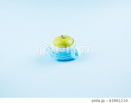 Green fresh apple in face mask. Covid19 concept 63861210