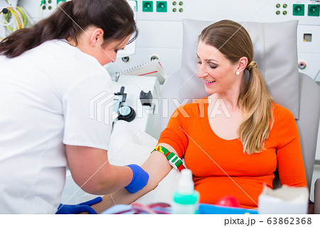 Nurse disinfecting puncture point before blood donation 63862368