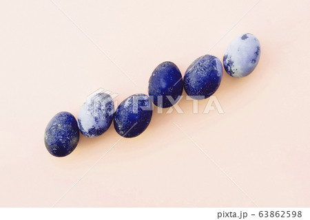 Natural dyed blue colored eggs on pastel beige background, top view. Natural dyed blue colored eggs on pastel beige background, top view. 63862598