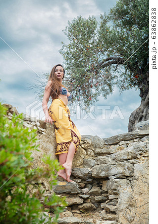 Lovely lady posing among antique ruins Lovely lady posing among antique ruins 63862838