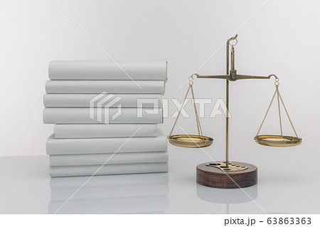 Wooden gavel with justice scales and open book, isolated on white 63863363