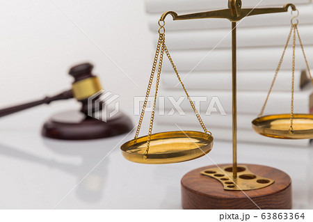 Wooden gavel with justice scales and open book, isolated on white Wooden gavel with justice scales and open book, isolated on white 63863364