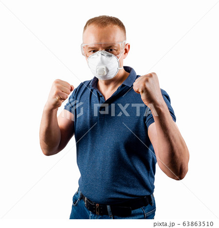 A man in a protective mask and glasses stands in a 63863510