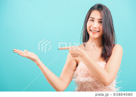 Smiling face Asian beautiful woman her point Smiling face Asian beautiful woman her point 63864080