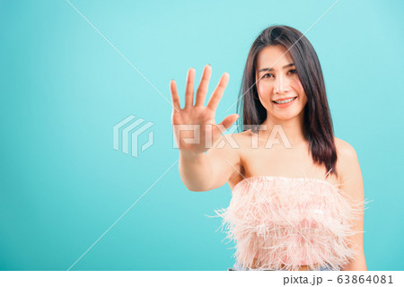 Smiling face Asian beautiful woman showing hand 63864081