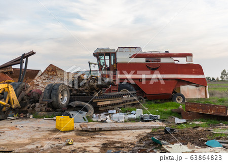 Abandoned agricultural machinery in a scrap yard 63864823