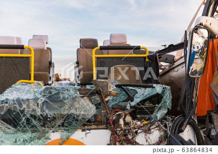 Detail of a crashed bus with no roof and broken front glass. Detail of a crashed bus with no roof and broken front glass. 63864834
