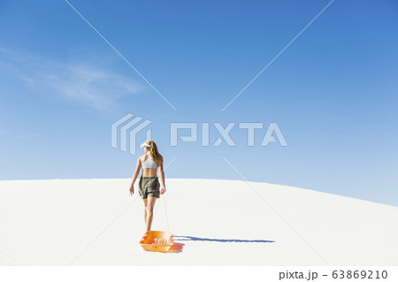 A teenage girl pulling a sled 63869210