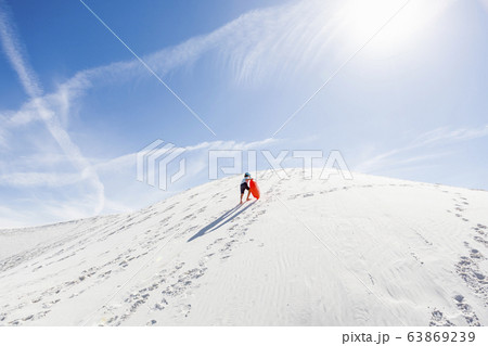 A young boy climbing sand dune A young boy climbing sand dune 63869239