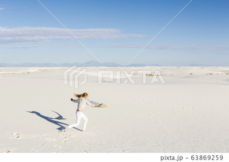 A teenage girl dancing in the dunes, 63869259
