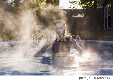A teenage girl swimming in a pool A teenage girl swimming in a pool 63869745
