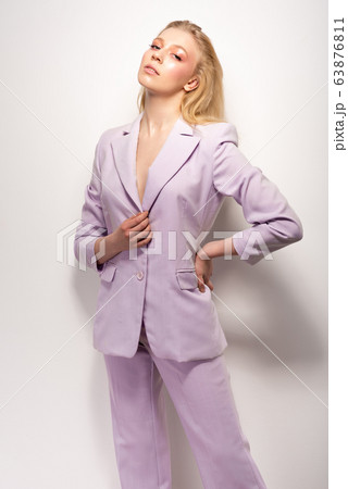 Young girl in a lilac business suit 63876811