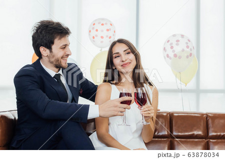 Young couple celebrating new year together, 63878034