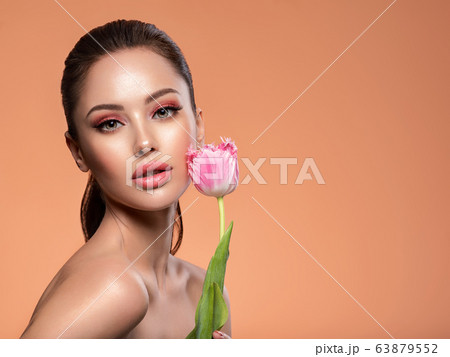 Beautiful white girl with flower. Stunning girl 63879552