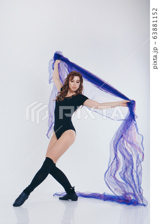A girl in a tracksuit on a white background. Gymnast with blue fabric. Healthy lifestyle concept, sports uniforms, world Cup, gym, specialized clothing, black uniforms, exercise 63881152