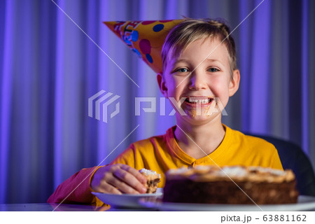Happy messy child after party. He ate a celebration cake 63881162