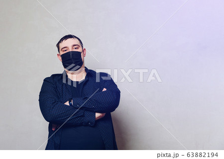 man in black shirt and black hospital mask on gray man in black shirt and black hospital mask on gray 63882194