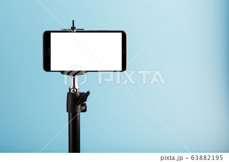 Mobile phone on a tripod with a clear white 63882195
