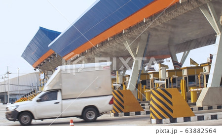 Antibacterial and antiviral treatment of toll roads in Thailand. Spraying chemical fluid over cars. Disinfection of vehicles roads. Pandemic covid-19. 63882564