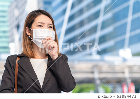 Young businesswoman wearing surgical mask Young businesswoman wearing surgical mask 63884473