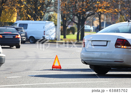 There is yellow triangle accident sign on road There is yellow triangle accident sign on road 63885702