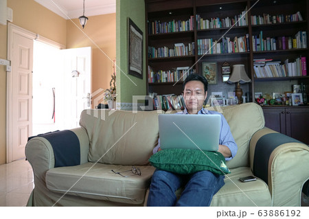 Asian Chinese businessman working on his laptop in Asian Chinese businessman working on his laptop in 63886192