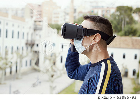 man using a virtual reality headset man using a virtual reality headset 63886793